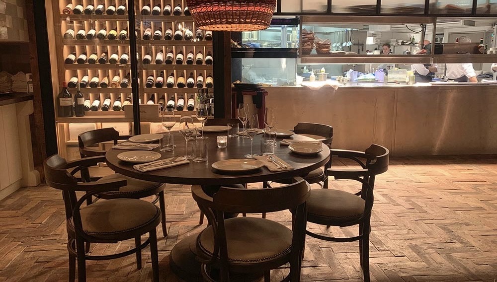 Table with cutlery overlooking the open kitchen