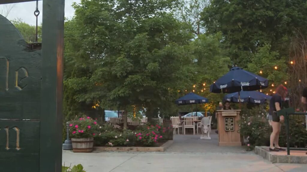 Twilight at Pineville Tavern with pink flowers and outdoor seating